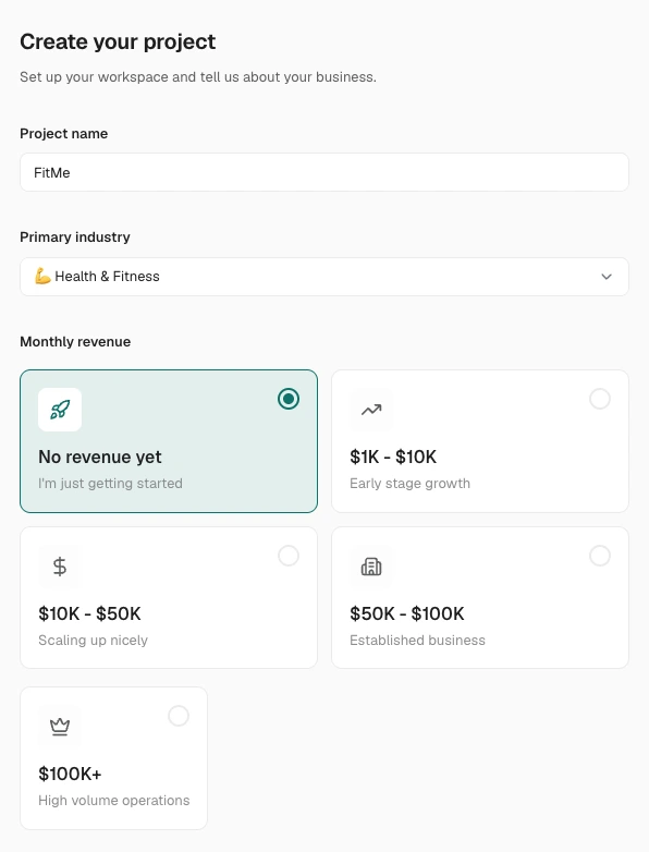 The Create your project step of the onboarding wizard, with the project name filled in as FitMe, Health & Fitness picked as the primary industry, and the monthly-revenue band cards below